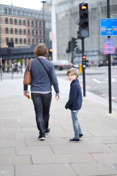 A man with a child on a city street. London, Great Britain.
