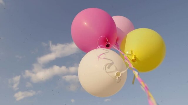balloons on a green meadow at sunset. Concept - lightness and freedom of movement, dream.