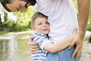 Young father with little boy, sunny spring day.