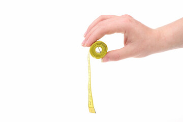 Hand holds roll of yellow tape for measuring with fingers