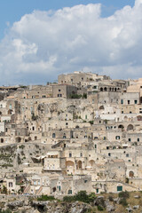 Fototapeta na wymiar Matera, Italy - May 20, 2017: Panoramic view of the city from the belvedere square with background the clouds in the sky