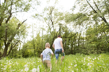 Young father with little boy, sunny spring day.