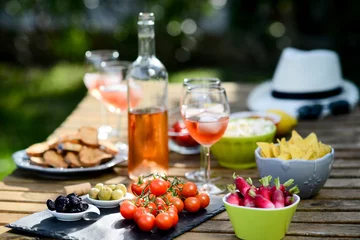 Garden poster Buffet, Bar holiday summer brunch party table outdoor in a house backyard with appetizer, glass of rosé wine, fresh drink and organic vegetables