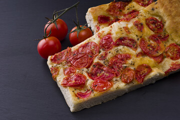 white pizza with tomatoes on the slate stone background