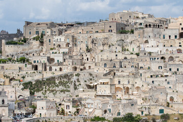 Fototapeta premium Matera, Italy - May 20, 2017: Panoramic view of the city from the belvedere square with background the clouds in the sky