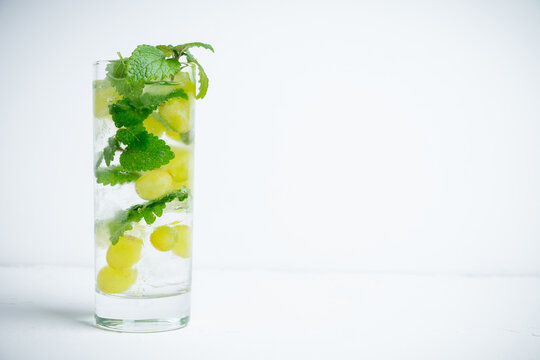 Grape mojito with fresh mint on the rustic background. Shallow depth of field.