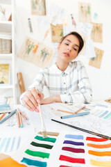 Portrait of a beautiful fashion designer woman working at workshop