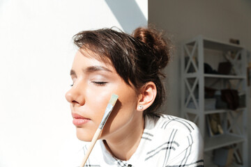Close up portrait of a girl artist with eyes closed