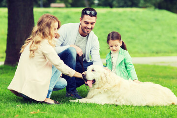 happy family with labrador retriever dog in park