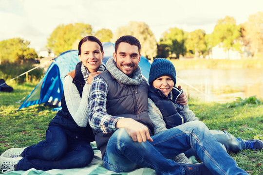 happy family with tent at camp site