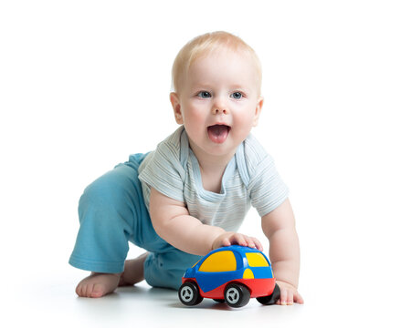 Baby boy playing with car toy isolated on white
