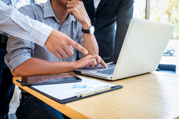 Teamwork process, business colleague meeting to discussing the new project business strategy plan with digital tablet and laptop. Briefing, brainstorming, consulting