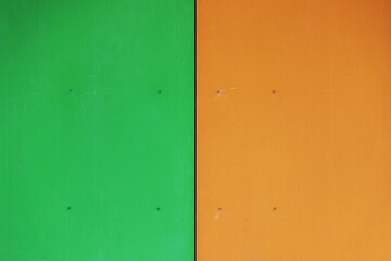 The wall of the house, trimmed with colorful panels, painted in bright colors. Green and orange.