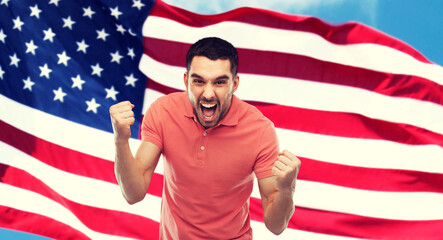 angry man showing fists over american flag