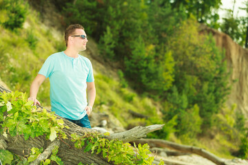 Man spending free time outside, looking at nature