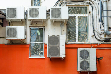 Chaotically located air conditioners on the wall. Element of urban urban landscape. Urban...