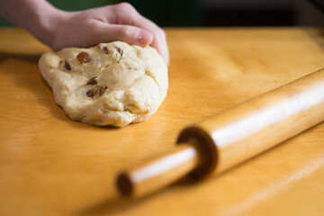 Woman kneading a dough on the table
