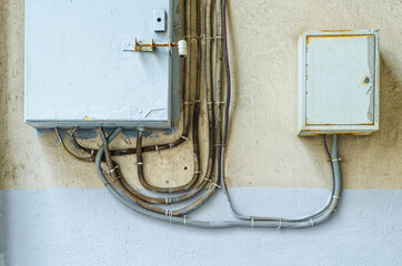 Electrical switchboard on the wall. Wiring to the electrical panel on the wall. Detail of the...