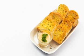 Garlic bread and herb bread slice on dish.
