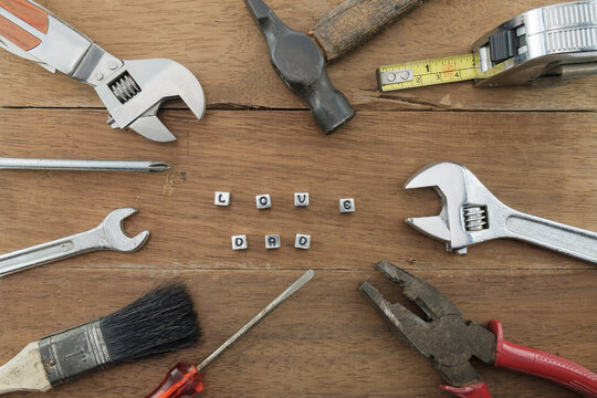 Mechanic tool / View of mechanic tool with alphabet cube on wood background. Father's day concept.