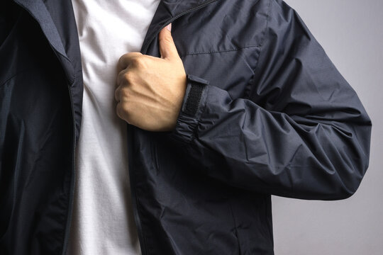 Man wearing black anti static or wet weather jacket or rain coat