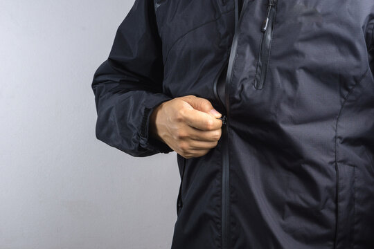 Man wearing black anti static or wet weather jacket or rain coat