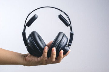 Fototapeta na wymiar Hand holding full ear or studio headphone