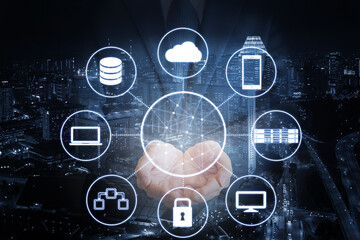 Double exposure of professional businessman hold all devices technology connecting with network and city of business background in blue tone