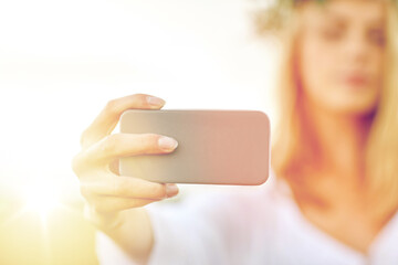 close up of woman taking selfie by smartphone