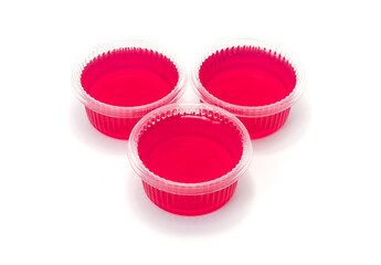 Red jelly in cup on white background.