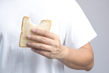 Hand holding sliced whole grain bread