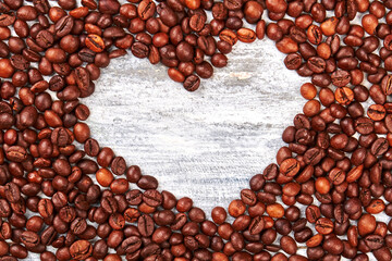 Heart from coffee beans. Coffee grain, wooden space.
