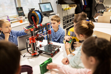 happy children with 3d printer at robotics school