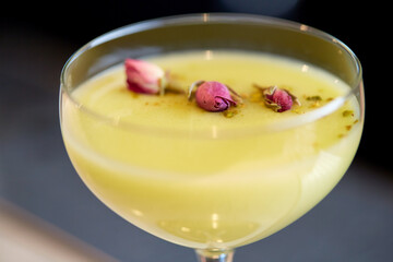 close up of glass with creamy cocktail at bar