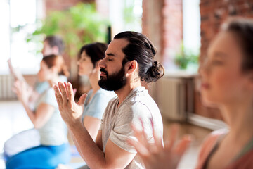 group of people meditating at yoga studio