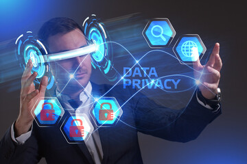 Fototapeta premium Business, Technology, Internet and network concept. Young businessman working in virtual reality glasses sees the inscription: Data privacy