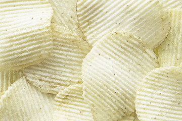 Beautiful white corrugated chips with paprika. The background.
