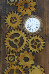 Wooden door in the cafe decorated in the form of clock gears and watches.