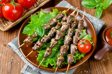 Chicken hearts on a barbecue sticks topped with sesame seeds