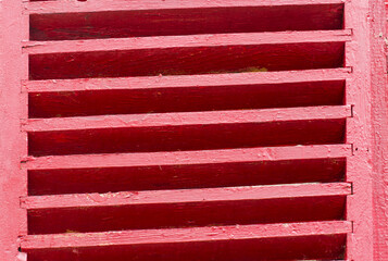 Old wooden shutters in red color