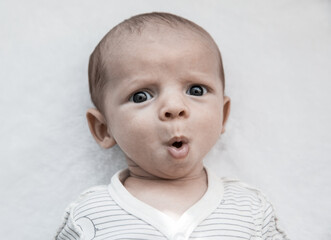 Portrait of cute surprised baby boy