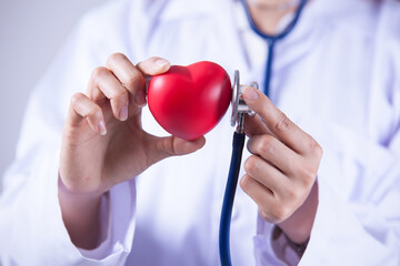 Doctor or cardiologist holding heart listening to heartbeat concept for healthcare and diagnosis...