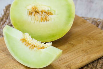 Honeydew Melon Slice on Wooden Cutting Board