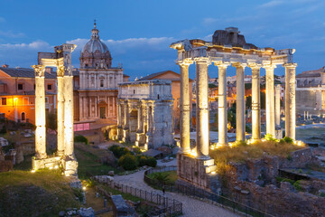 Fototapeta na wymiar Ancient ruins of a Roman Forum or Foro Romano during evening blue hour in Rome, Italy. View from Capitoline Hill