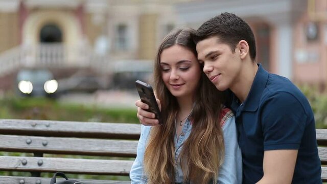 Romantic couple watching video on smartphone