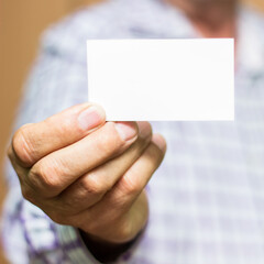 Man showing blank white business card 