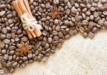Coffee beans with anise and cinnamon on burlap.