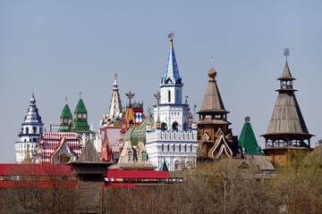 Wooden and multicolored stone towers on the background of the sky