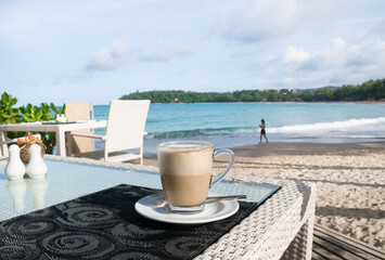 Shot of Latte Coffee cup on beautiful  table by the beach.