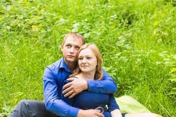 summer holidays, love, romance and people concept - happy smiling young couple hugging outdoors